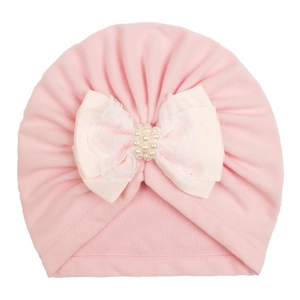 Pink velvet baby turban hat featuring elegant silk ribbon bow with lace and pearls