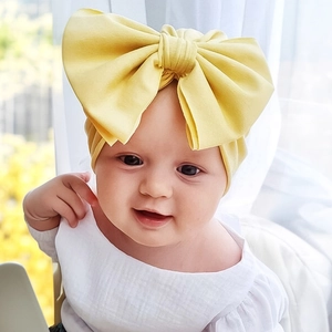 Close-up of bright yellow baby turban headband featuring a large soft fabric bow