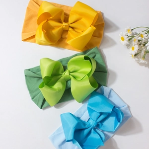 Three cute baby headbands with large ribbed bows in yellow, green and blue colors