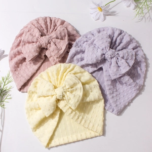 Three-piece baby bow turban hats in pink, purple, and yellow with textured knit fabric