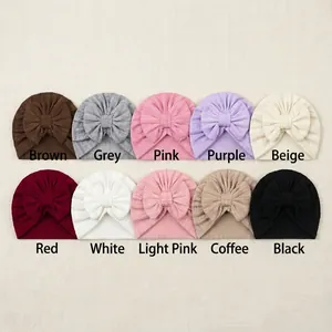 Set of ten colorful striped newborn hats with soft bow accents in various soft knit colors