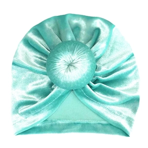 Detailed close-up of velvet donut baby turban in aqua mint showing soft fabric texture