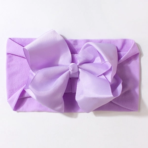 Detail of light purple stretchy baby headband with a large layered ribbed fabric bow