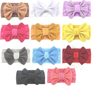 Set of 11 colorful waffle knit baby headbands with large soft bows for infants