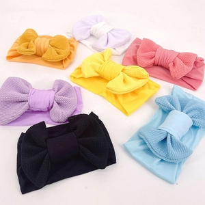 Detailed macro view of colorful baby headbands with large waffle texture bows