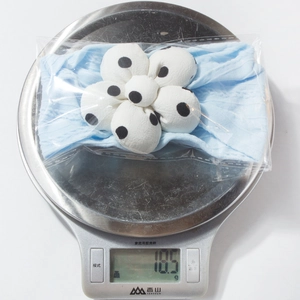 Macro shot of a light blue baby headband with a polka dot flower showing 18.5g weight