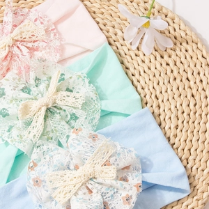 Detailed set of soft nylon baby headbands with delicate floral lace bows in pastel colors