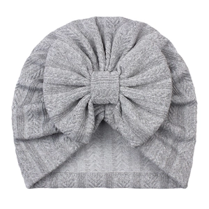 Gray striped baby turban hat with a large bow detail for newborns on white background