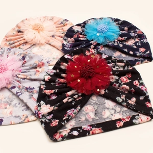 Set of four floral baby beanies with large lace flowers and golden stars detail