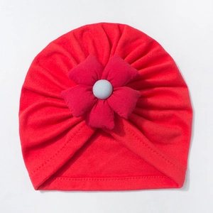 Soft red baby turban hat featuring a large 3D flower decoration and knitted fabric