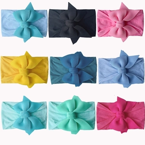 Set of nine colorful nylon baby headbands with large soft bows in various vibrant candy colors