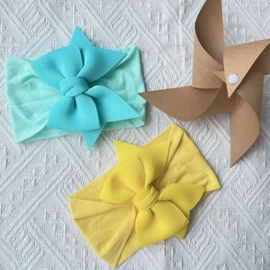 Soft nylon baby headbands with large bows in mint green and bright yellow colors