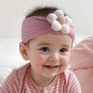 Detailed view of an infant pink floral headband with 3D soft jacquard flower petals