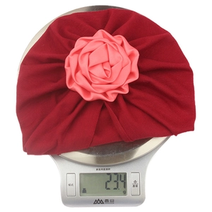 Weight display of 23.4g for dark red baby turban hat with a large pink rose flower