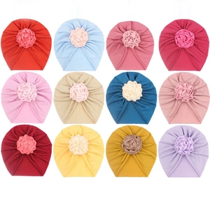 Set of 12 colorful baby turban hats with floral details in soft knit fabric
