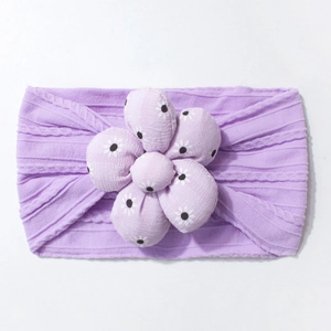 Detail of lavender baby headband with textured knit and white floral pattern flower