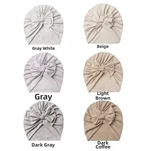 Detail view of baby bow hats in six colors including beige, grey and dark coffee