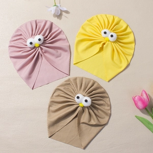 Vue détaillée des turbans pour bébé avec de mignons grands yeux en rose, jaune et marron