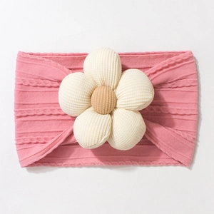 Close-up of pink knit baby headband featuring a large beige 3D floral texture