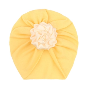 Detail of baby turban hat in lemon yellow with a large white satin pleated flower