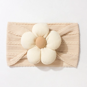 Detailed view of beige knitted baby headband featuring a soft 3D corduroy flower