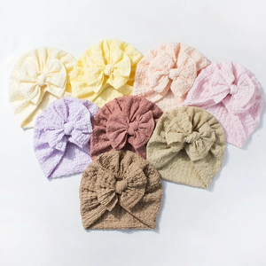 Set of eight soft breathable baby turban hats with large bows in various pastel colors