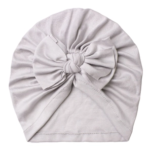 Macro shot of light gray newborn turban hat featuring soft ribbed cotton and bow detail