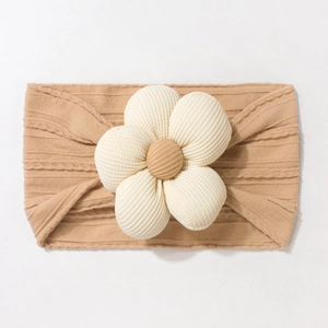 Detail of baby headband featuring a large cream floral knit on khaki ribbed fabric