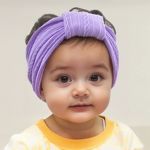 Close-up of baby girl wearing a soft purple knotted nylon headband with a stylish jacquard texture