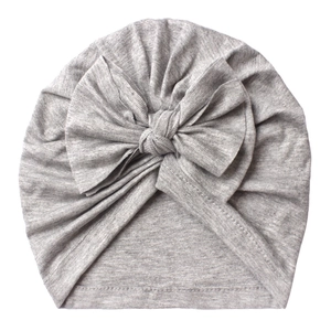 Detailed texture of light grey baby turban hat with a large decorative bow