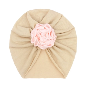Infant beige turban hat with large pink satin rose flower decoration for newborn girls