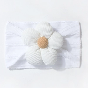 Close-up of white ribbed knit baby headband featuring a large corduroy flower with yellow core