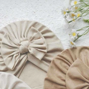 Soft ribbed cotton baby turban hats with large bows in beige and khaki colors