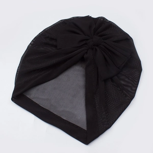 Close-up of black mesh baby turban hat with a large decorative bow and soft texture