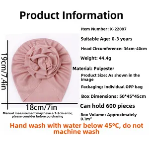 Detailed size guide for pink ribbed knit baby turban hat with decorative rosette