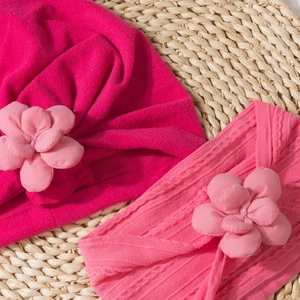 Detailed view of pink cotton baby turban hat and headband with handmade 3D flowers