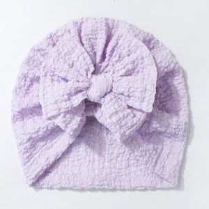 Detailed close-up of light purple baby turban hat featuring a large soft bow and bubble texture