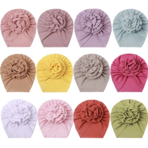 Detailed grid of rib-knit baby hats featuring large decorative flower designs in 12 colors