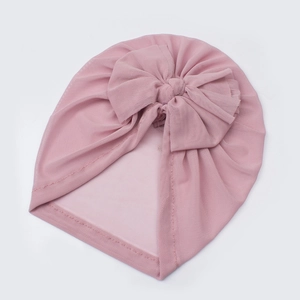 Detailed texture of baby soft mesh turban hat featuring a large decorative lace bow