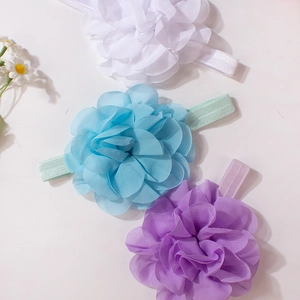 Detailed close-up of three soft chiffon flower headbands for babies in pastel colors