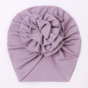 Detail of lavender ribbed knit baby turban hat featuring a large 3D layered fabric flower