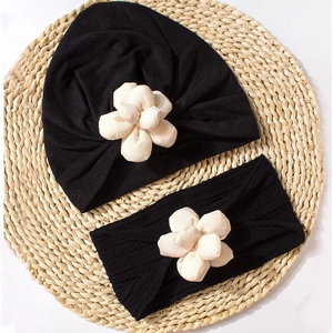 Detailed set of black pleated baby turban and ribbed headband with 3D floral accents