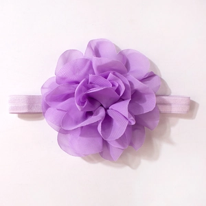 Detailed close-up of handmade purple chiffon flower headband with soft elastic band