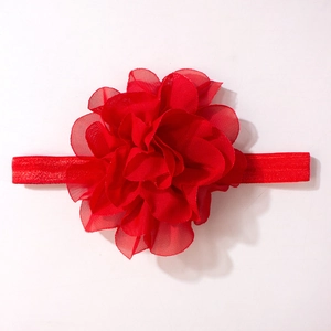 Detail of red handmade chiffon flower headpiece with elastic band for infants