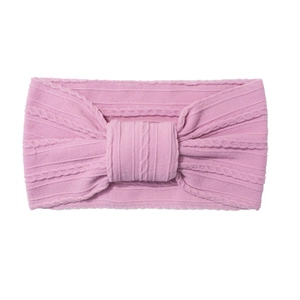 Soft pink cable knit baby headband with a wide decorative bow on white background