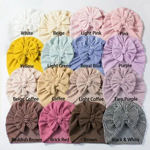 Collage of striped newborn knot beanies in sixteen diverse colors with large bows