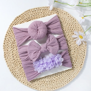 Ensemble de trois bandeaux pour bébé avec nœuds violets et fleurs sur tissu côtelé