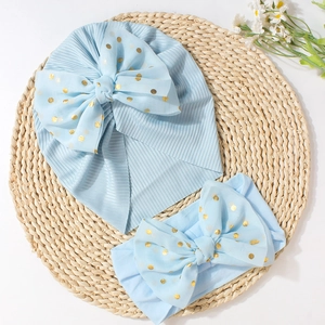 Detail of light blue baby turban and nylon headband with gold polka dot mesh bows