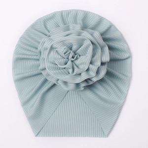 Detail of light blue ribbed infant turban hat with a large soft decorative flower knot