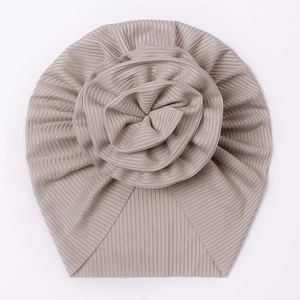 Ribbed baby turban hat with a large pleated flower in soft champagne knit fabric